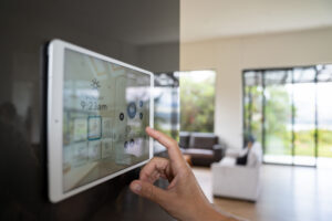 Close-up on a person using a home automation system to control their home.